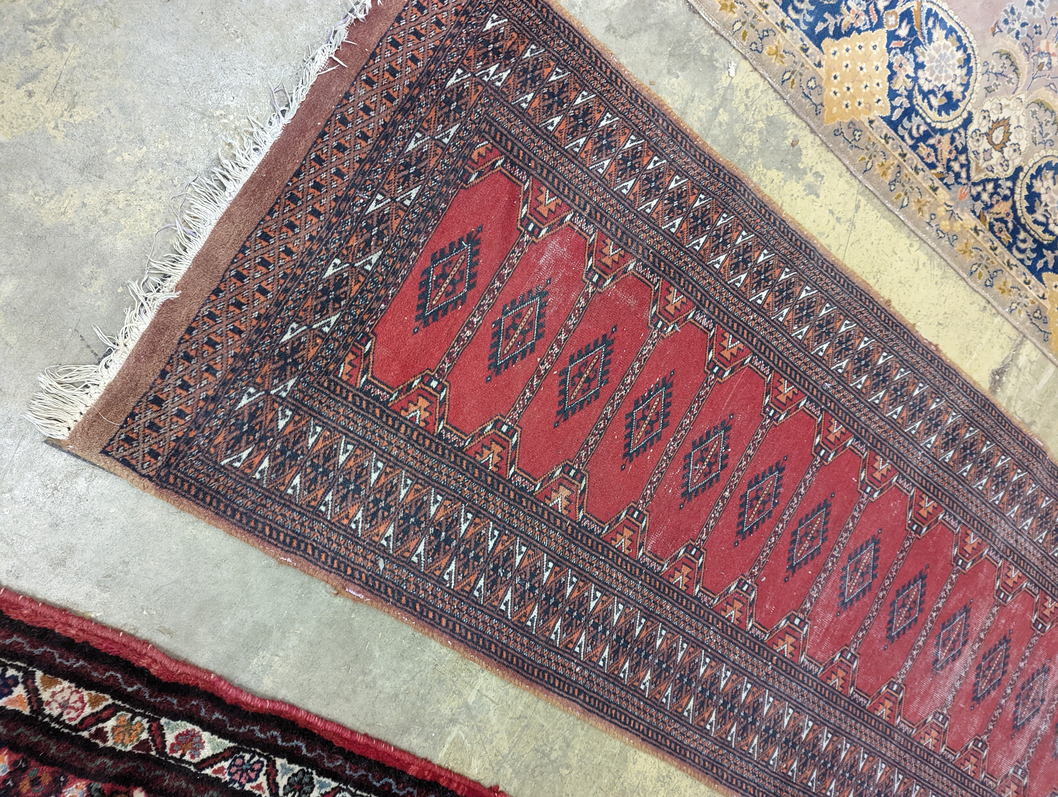 A North West Persian red ground runner and a Bokhara runner, larger approx. 290 x 78cm